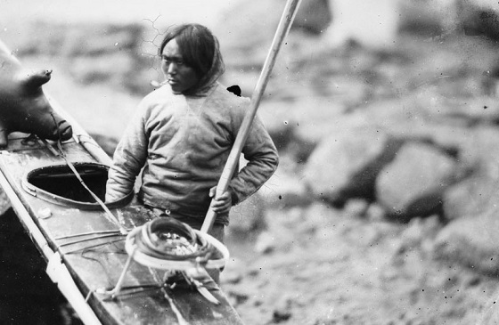 An Inuit hunter beside his qajaq, coiled harpoon line on the foredeck
